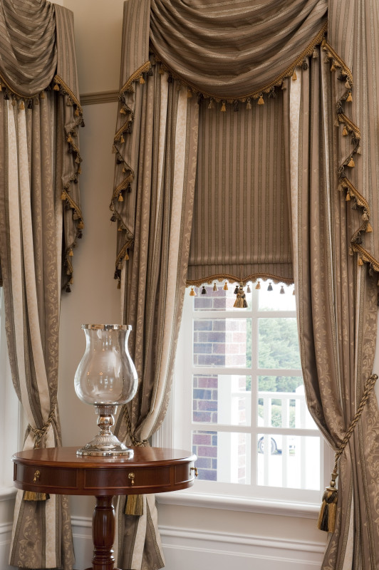 Drapes with custom made Swag and Tails and a matching bonded Roller Blind by O’Gormans